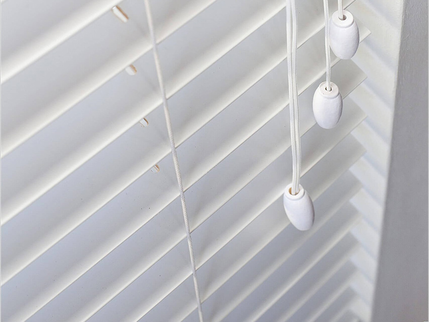 Luxurious white venetian blinds on a home window